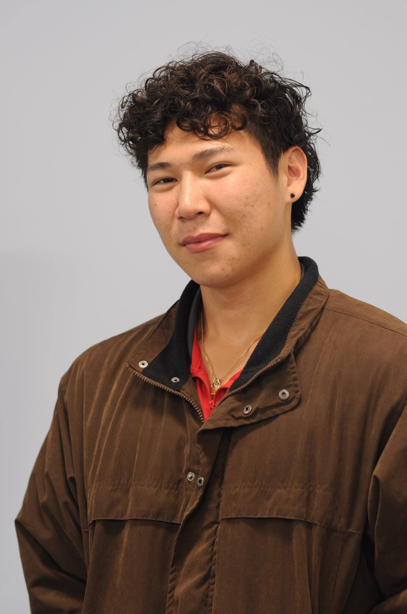 An informal portrait of a young man in a room 