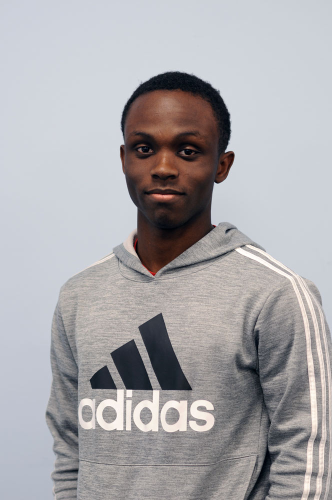 A three quarter portrait of a young man smiling.